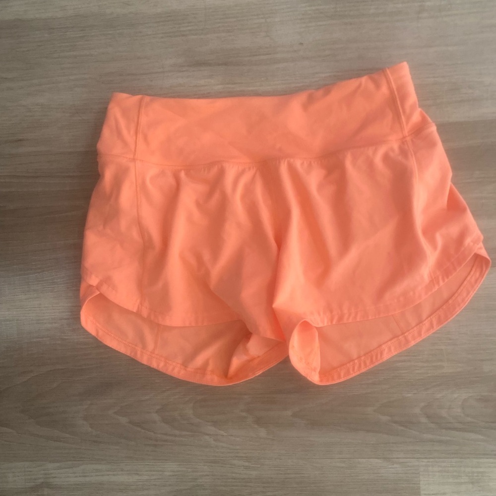 Lululemon orange shorts, size 4-6. Never worn.